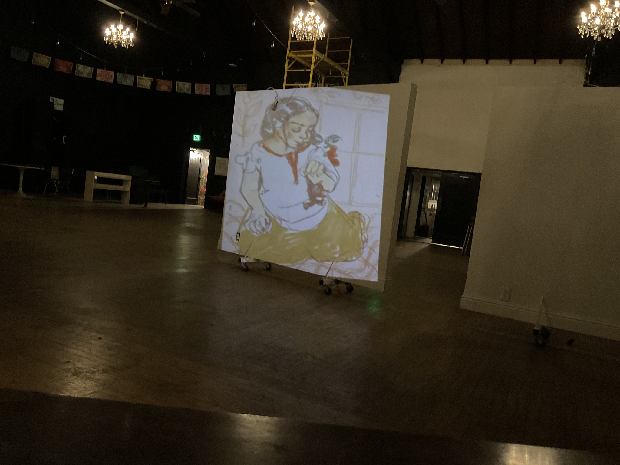 Light projection artwork on a large canvas in a dark gallery space